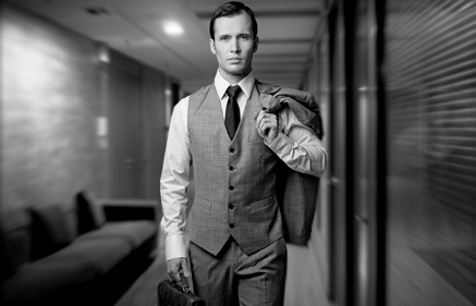 Services, a man walking with his coat on the shoulder and briefcase in the other hand